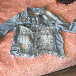 Distressed Jean jacket in size medium. Light wash